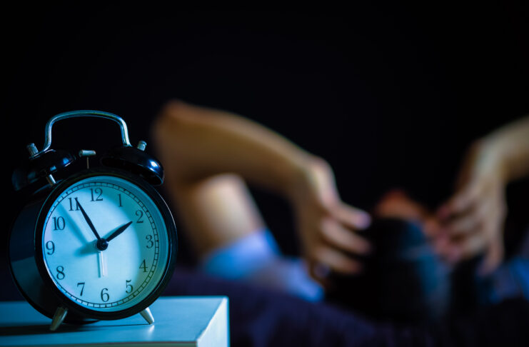 asian man in bed suffering insomnia and sleep disorder thinking about his problem at night