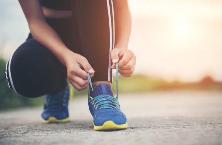 close-up-shoes-female-runner-tying-her-shoes-for-a-jogging-exercise