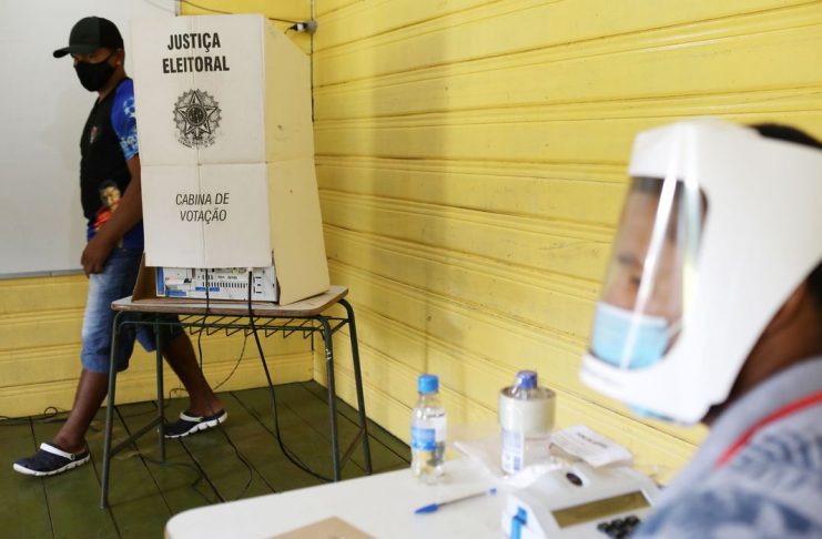 A man walks from a polling booth during municipal elections along the Negro River banks, where Ribeirinhos (forest dwellers) live, in Catalao, Brazil, November 15, 2020.   REUTERS/Bruno Kelly